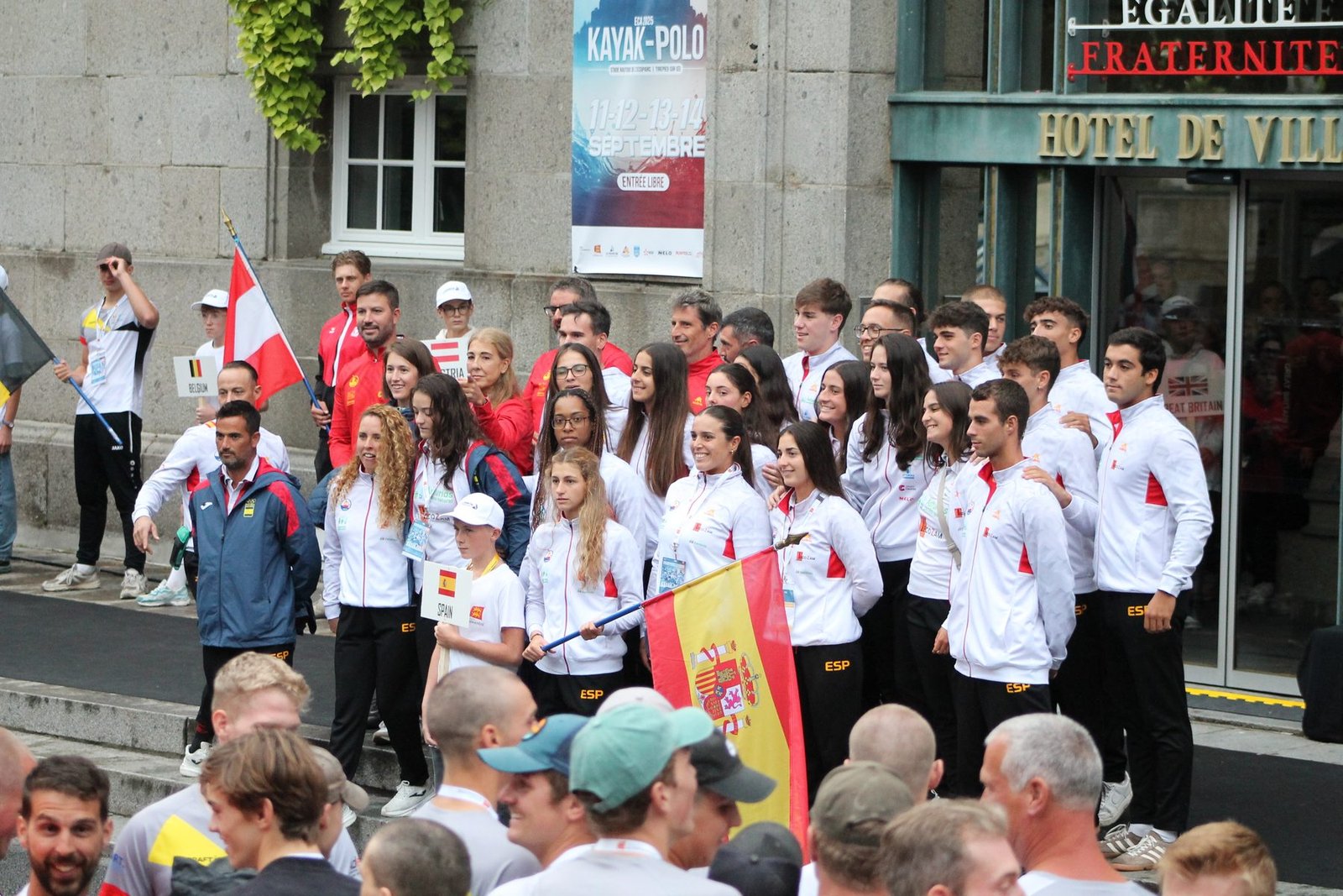 The Spanish kayak polo team posing together outside Avranches' town hall during the ECA 2025 European Championships.
