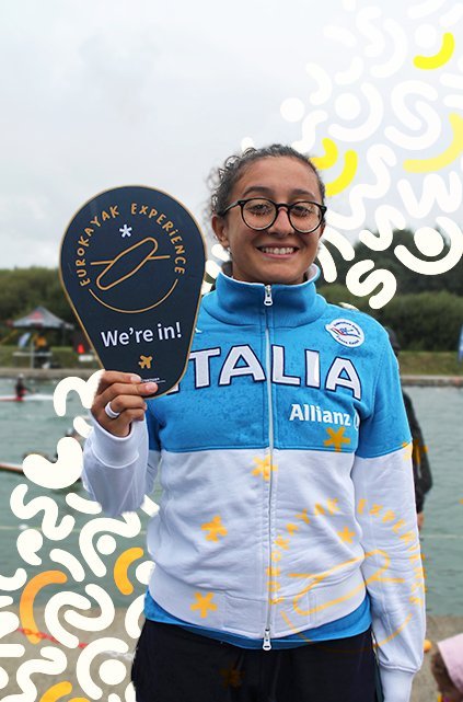 A representative of Kayak Club Arenzano holding a 'EuroKayak Experience — We're in!' sign.