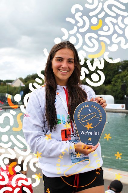 A representative of Piragua Madrid holding a 'EuroKayak Experience — We're in!' sign.