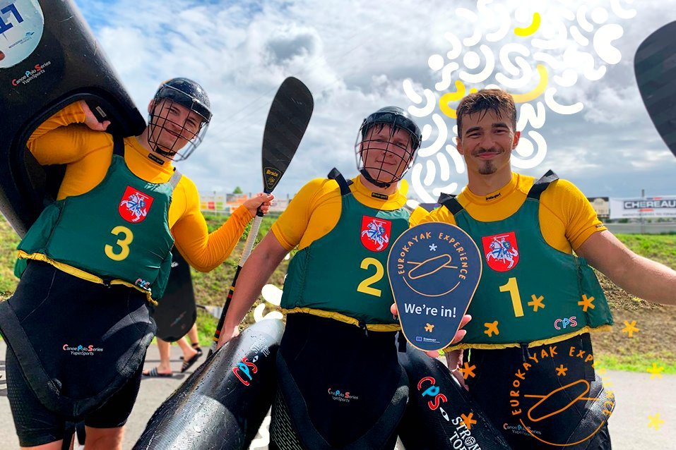 Three players from AVSK Trakai holding a 'EuroKayak Experience — We're in!' sign.